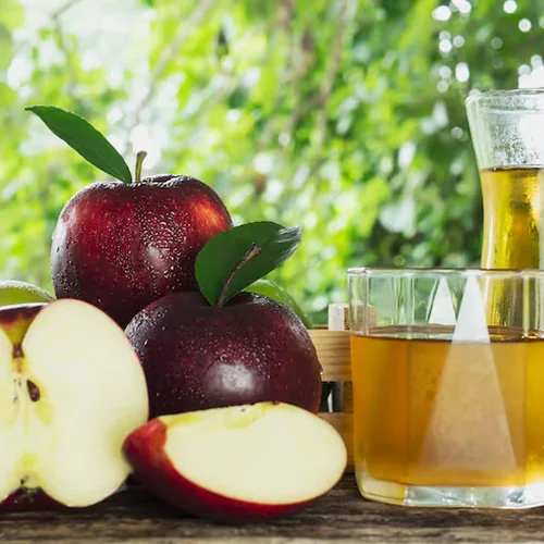 Apple cider vinegar with fresh red apples